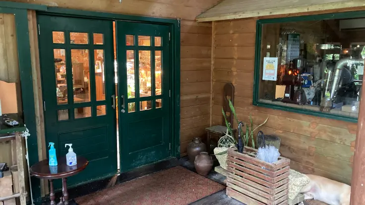 fuucafe(フーカフェ)のエントランス。緑に囲まれたログハウス風の外観が迎えてくれる。